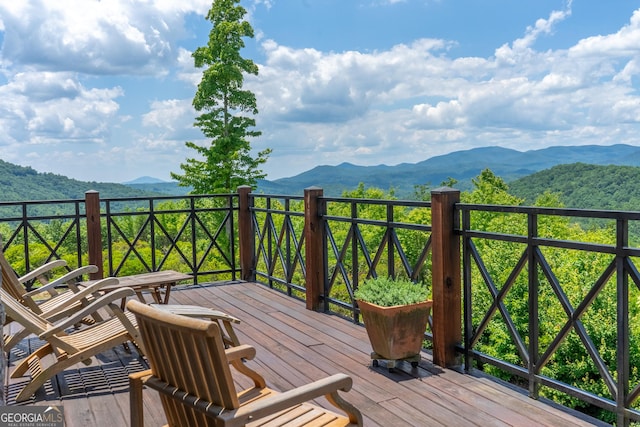 wooden deck featuring a mountain view