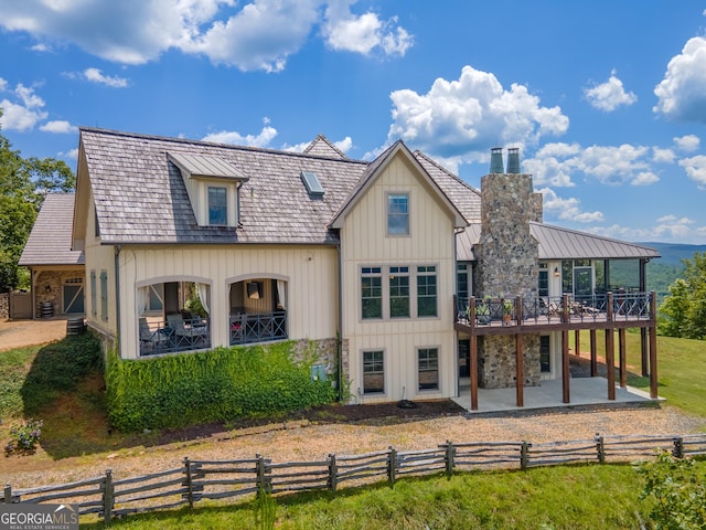 rear view of property with a patio area and a wooden deck