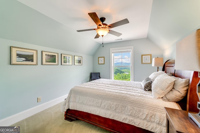 carpeted bedroom with ceiling fan and lofted ceiling