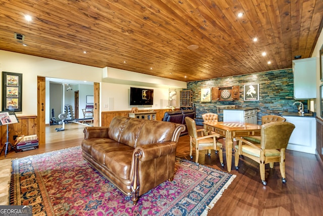 living room with wood-type flooring, wood ceiling, and wood walls