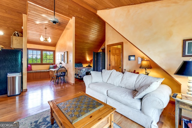 living room featuring ceiling fan with notable chandelier, light hardwood / wood-style floors, vaulted ceiling, and wooden ceiling