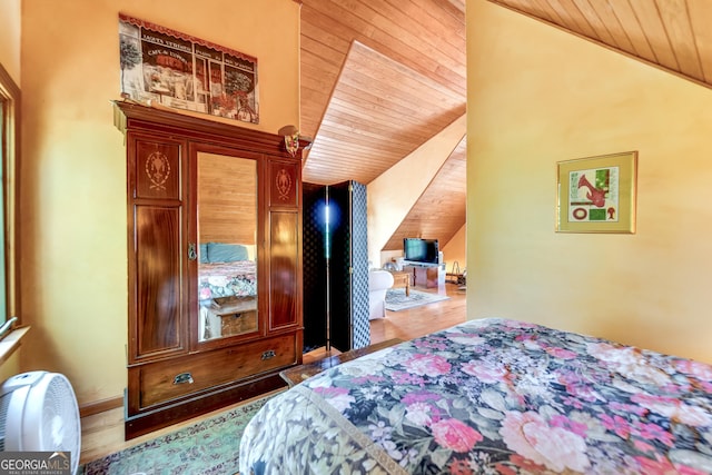 bedroom featuring hardwood / wood-style floors, wooden ceiling, and lofted ceiling