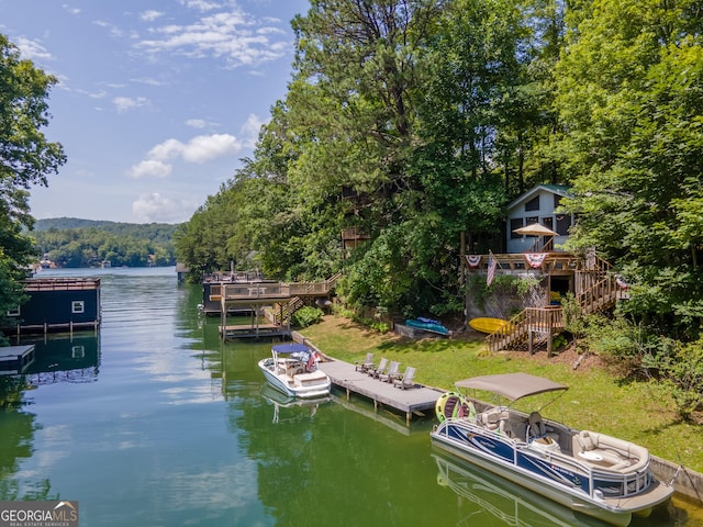 dock area featuring a deck with water view