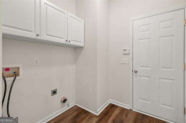 washroom with hookup for an electric dryer, hookup for a washing machine, dark hardwood / wood-style flooring, and cabinets