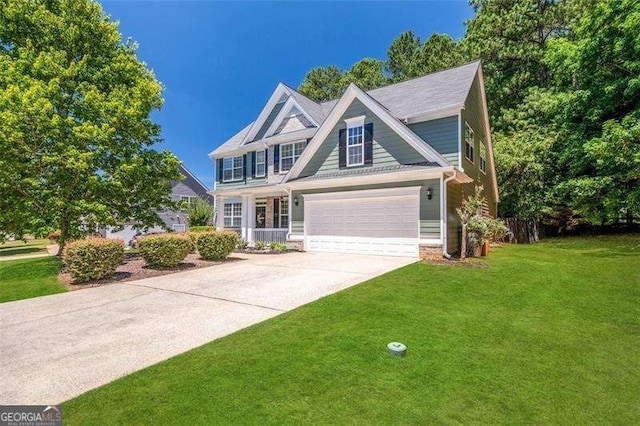 view of front of property featuring a front yard and a garage