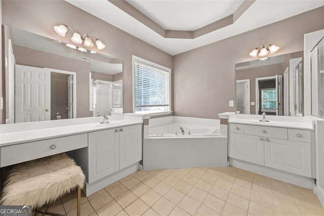 bathroom with tile patterned flooring, vanity, a tray ceiling, and independent shower and bath