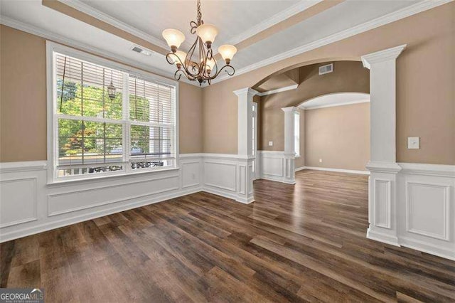 unfurnished dining area with decorative columns, ornamental molding, and a notable chandelier