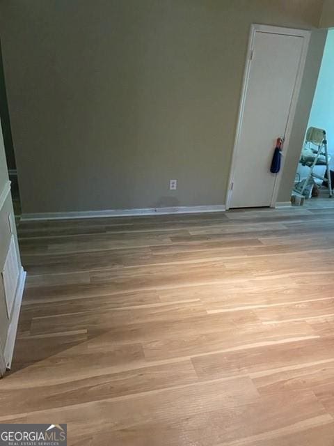 unfurnished room with light wood-type flooring