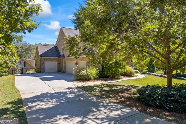 view of home's exterior with a lawn, fence, concrete driveway, a garage, and brick siding