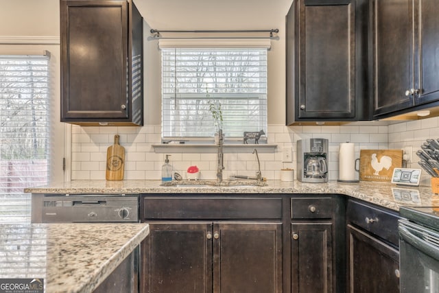 kitchen featuring dark brown cabinetry, plenty of natural light, and backsplash