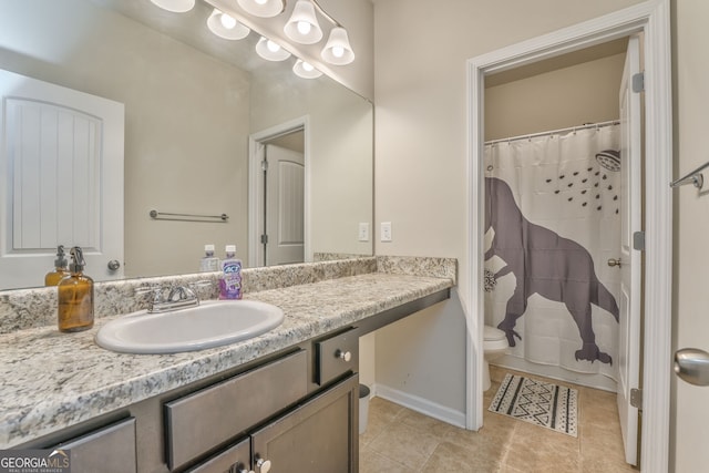 bathroom featuring tile patterned flooring, curtained shower, vanity, and toilet