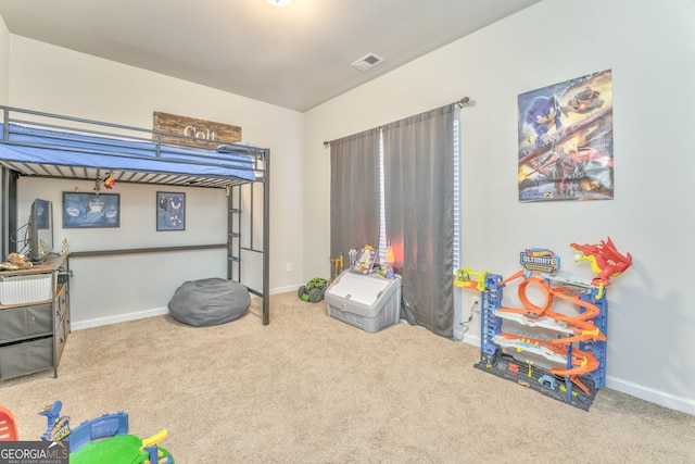 carpeted bedroom featuring visible vents and baseboards