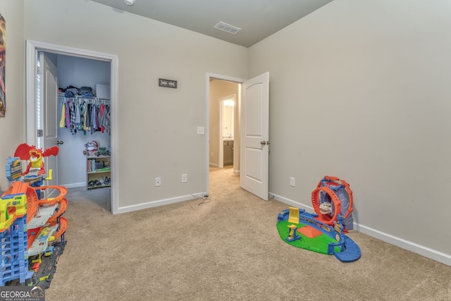 playroom with visible vents, light carpet, and baseboards