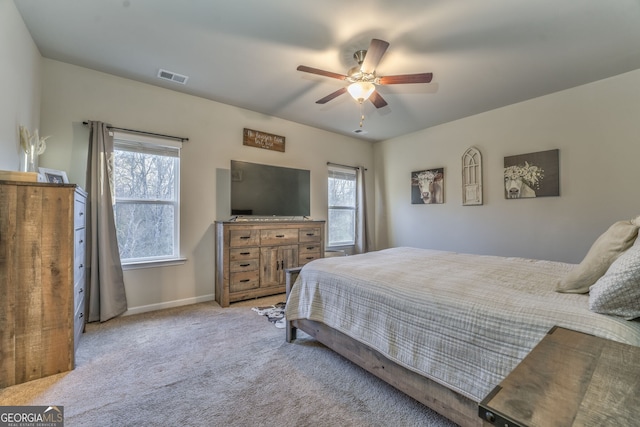 bedroom with light carpet, baseboards, visible vents, and a ceiling fan