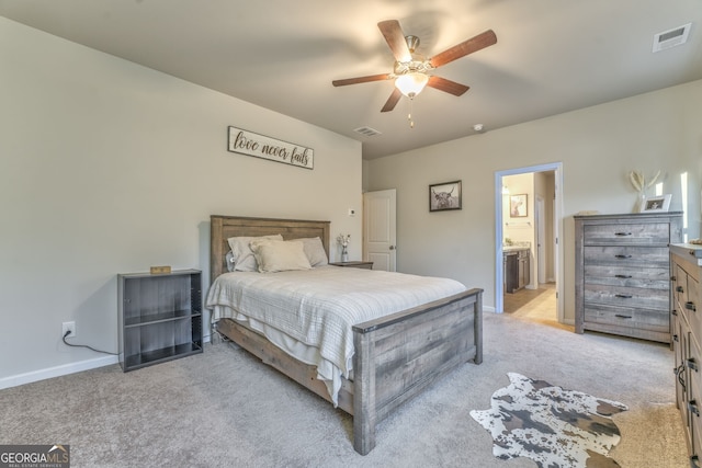 bedroom with visible vents, light carpet, and baseboards