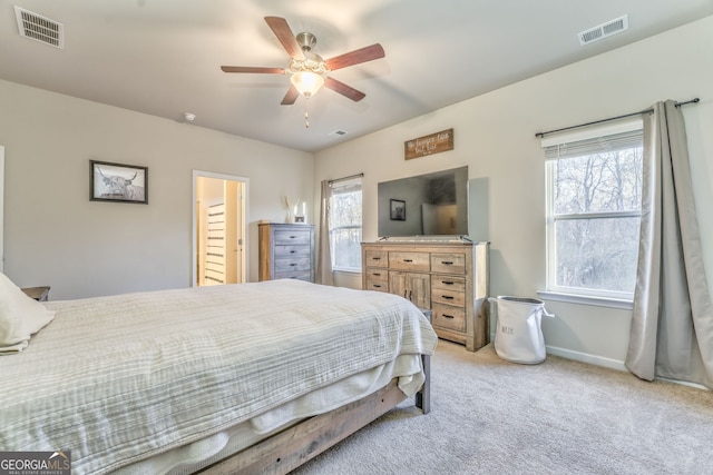 bedroom featuring light carpet, a ceiling fan, visible vents, and baseboards