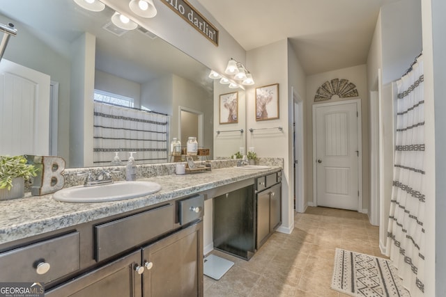 full bath featuring double vanity, tile patterned flooring, a sink, and visible vents