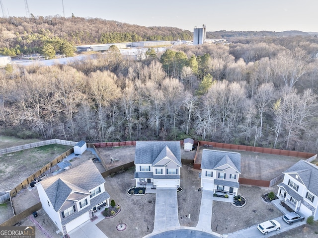 birds eye view of property with a view of trees