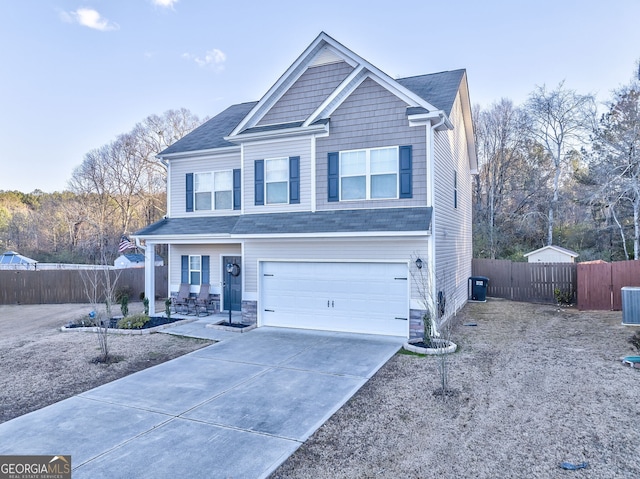 view of front facade with concrete driveway, an attached garage, fence, and cooling unit