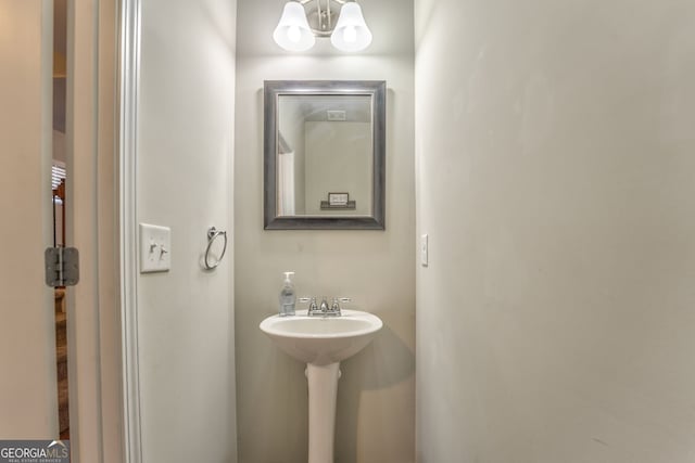 bathroom with a chandelier