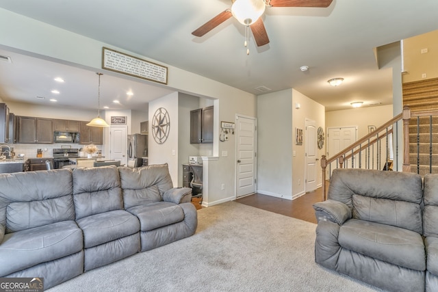 carpeted living room with baseboards, visible vents, a ceiling fan, stairs, and recessed lighting