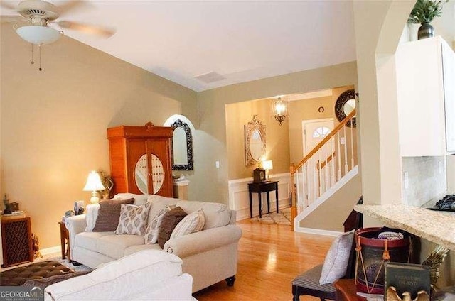 living room featuring hardwood / wood-style floors and ceiling fan