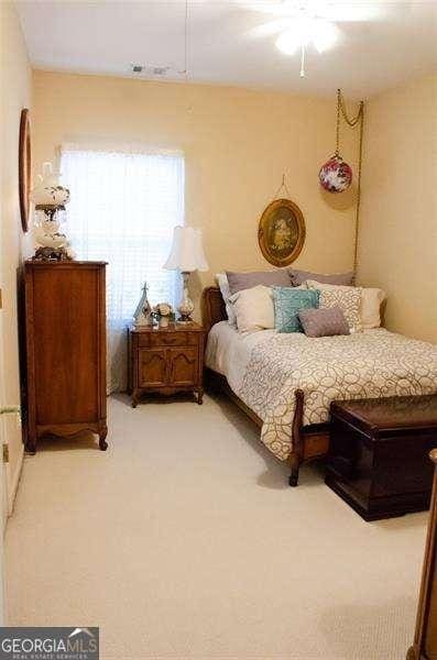 carpeted bedroom featuring ceiling fan