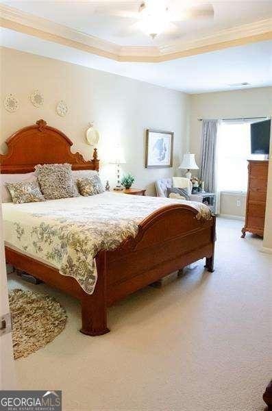 bedroom featuring carpet flooring and ornamental molding