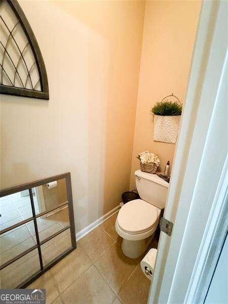 bathroom with tile patterned flooring and toilet