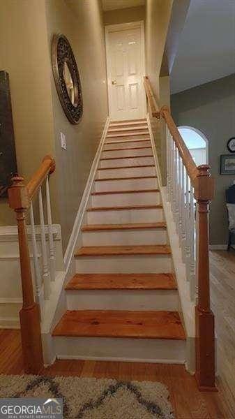 staircase featuring wood-type flooring