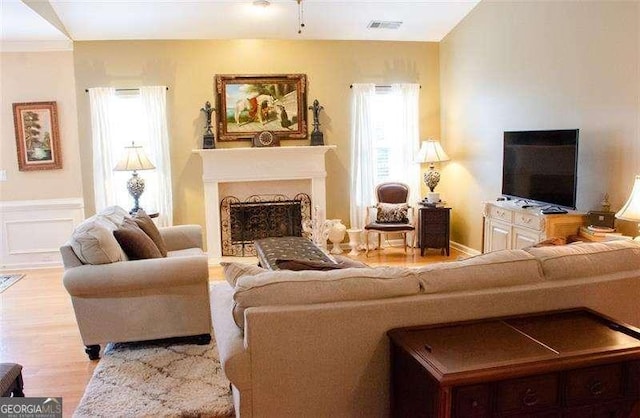 living room with plenty of natural light and light hardwood / wood-style floors