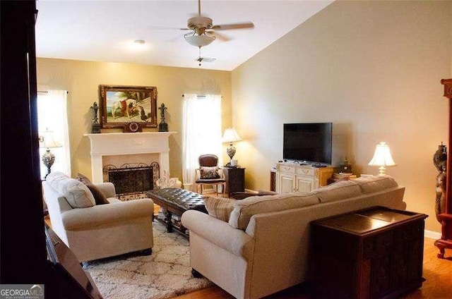 living room featuring ceiling fan and light hardwood / wood-style floors