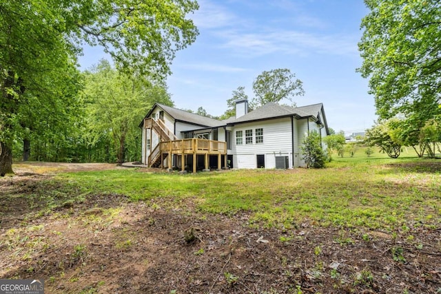 back of house with a yard, a deck, and cooling unit