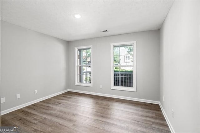 spare room with dark hardwood / wood-style floors