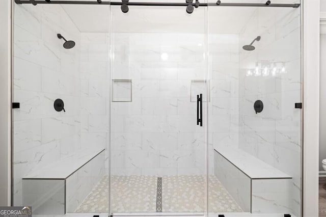 bathroom featuring a shower with door