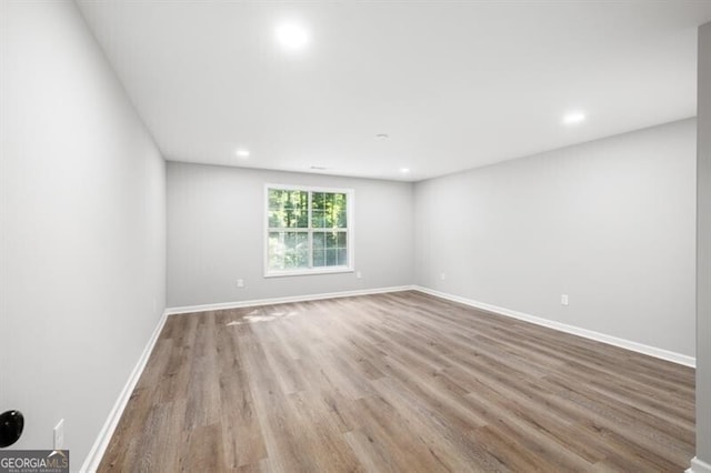 unfurnished room featuring hardwood / wood-style flooring