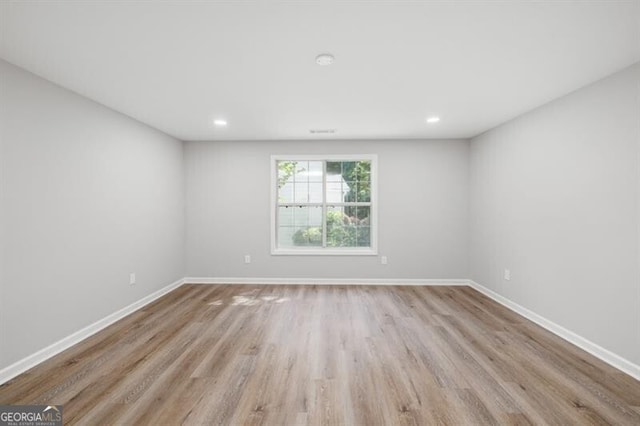 empty room with light hardwood / wood-style floors