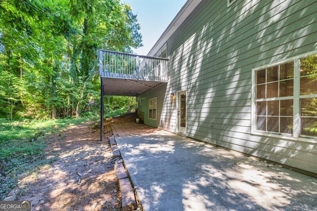 view of side of home featuring a patio and a deck