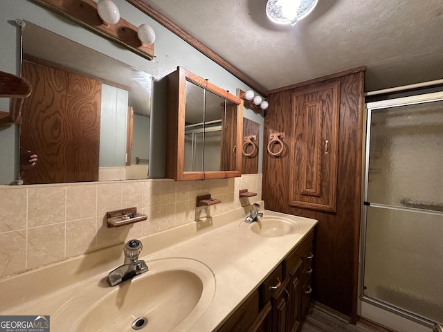 bathroom with decorative backsplash, walk in shower, and vanity