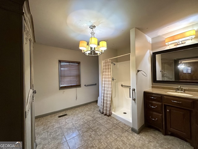 bathroom with a notable chandelier, curtained shower, and vanity