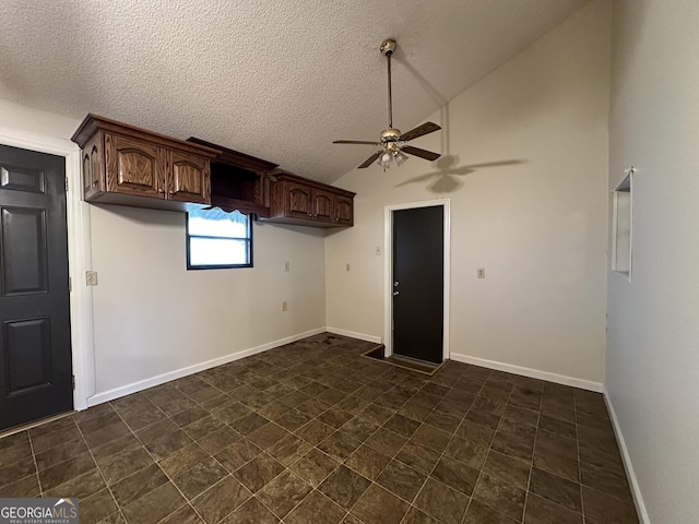 laundry area with ceiling fan and a textured ceiling