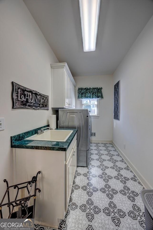 washroom featuring washer and dryer and cabinets