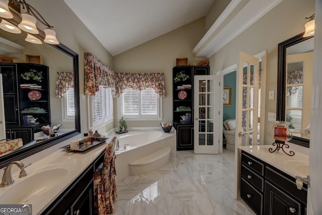 bathroom featuring vanity, a bath, and lofted ceiling