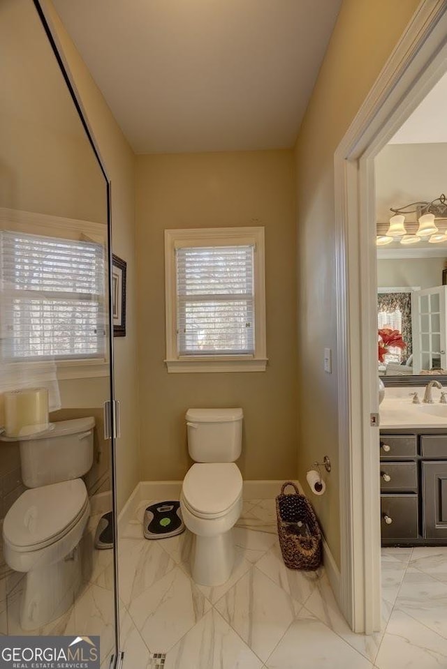 bathroom featuring vanity, toilet, and a wealth of natural light