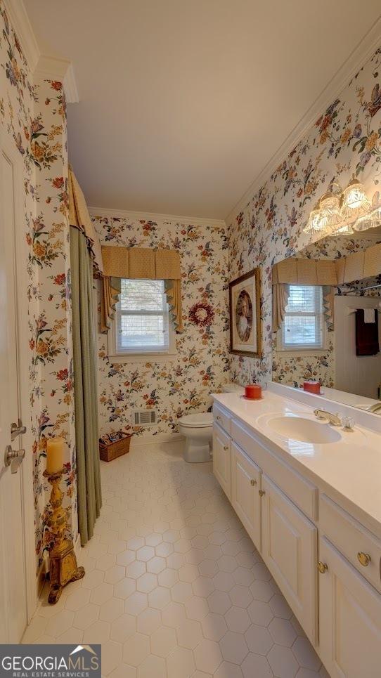 bathroom featuring tile patterned flooring, vanity, toilet, and ornamental molding