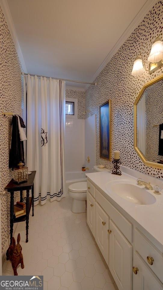 full bathroom featuring tile patterned floors, crown molding, toilet, vanity, and shower / tub combo