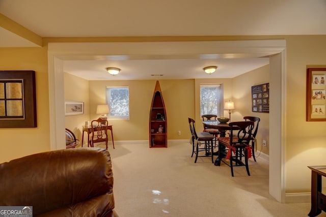 dining area with a healthy amount of sunlight and light colored carpet