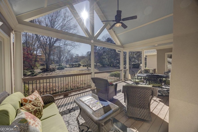 wooden terrace featuring an outdoor living space and ceiling fan