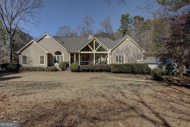 back of property featuring covered porch