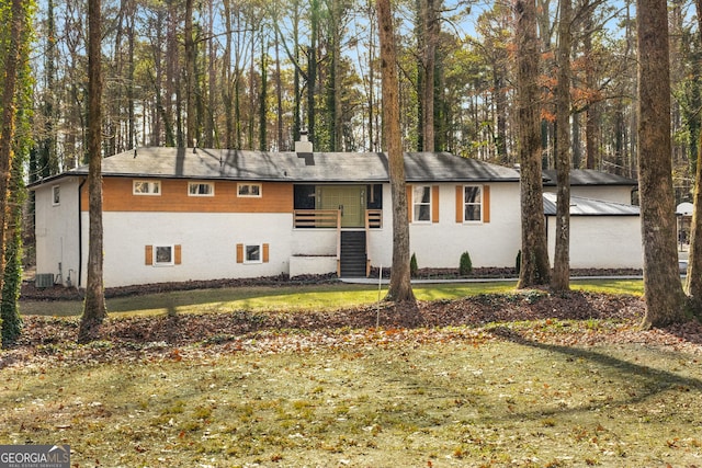 ranch-style home featuring central AC unit and a front yard